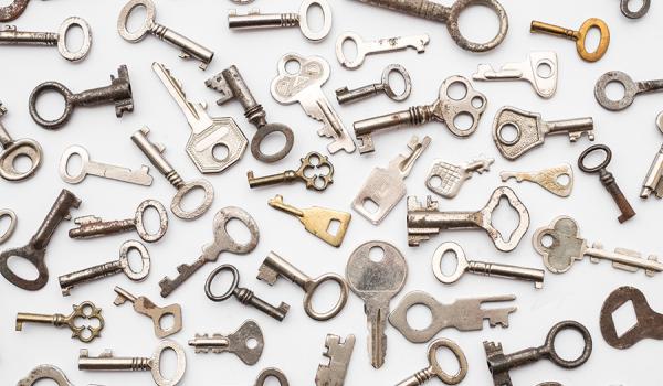 Assorted metal keys on a white background
